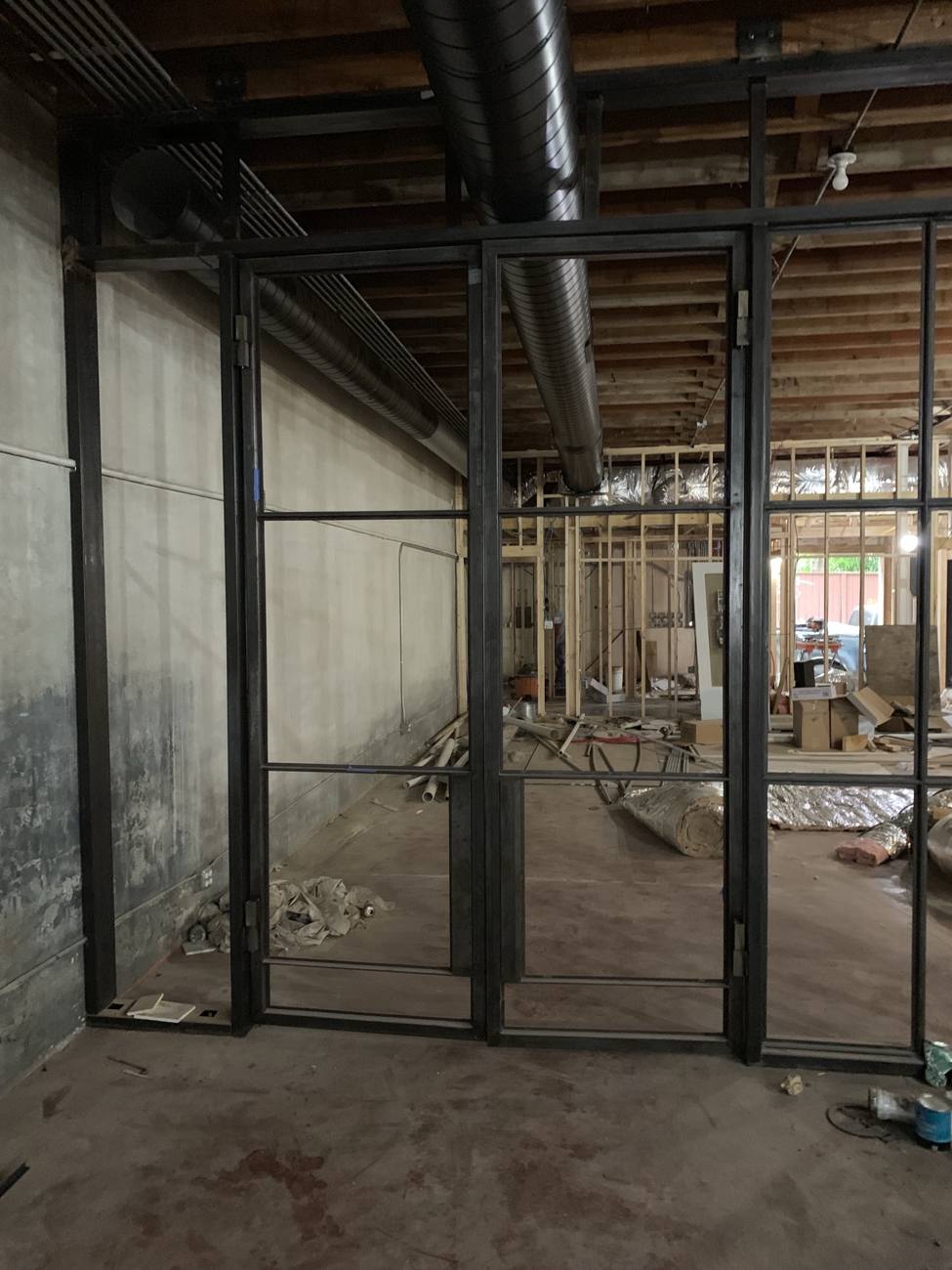 Interior steel wall and door frames installed before glass